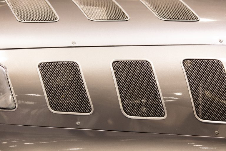 Close up detail on a vintage silver sports car.